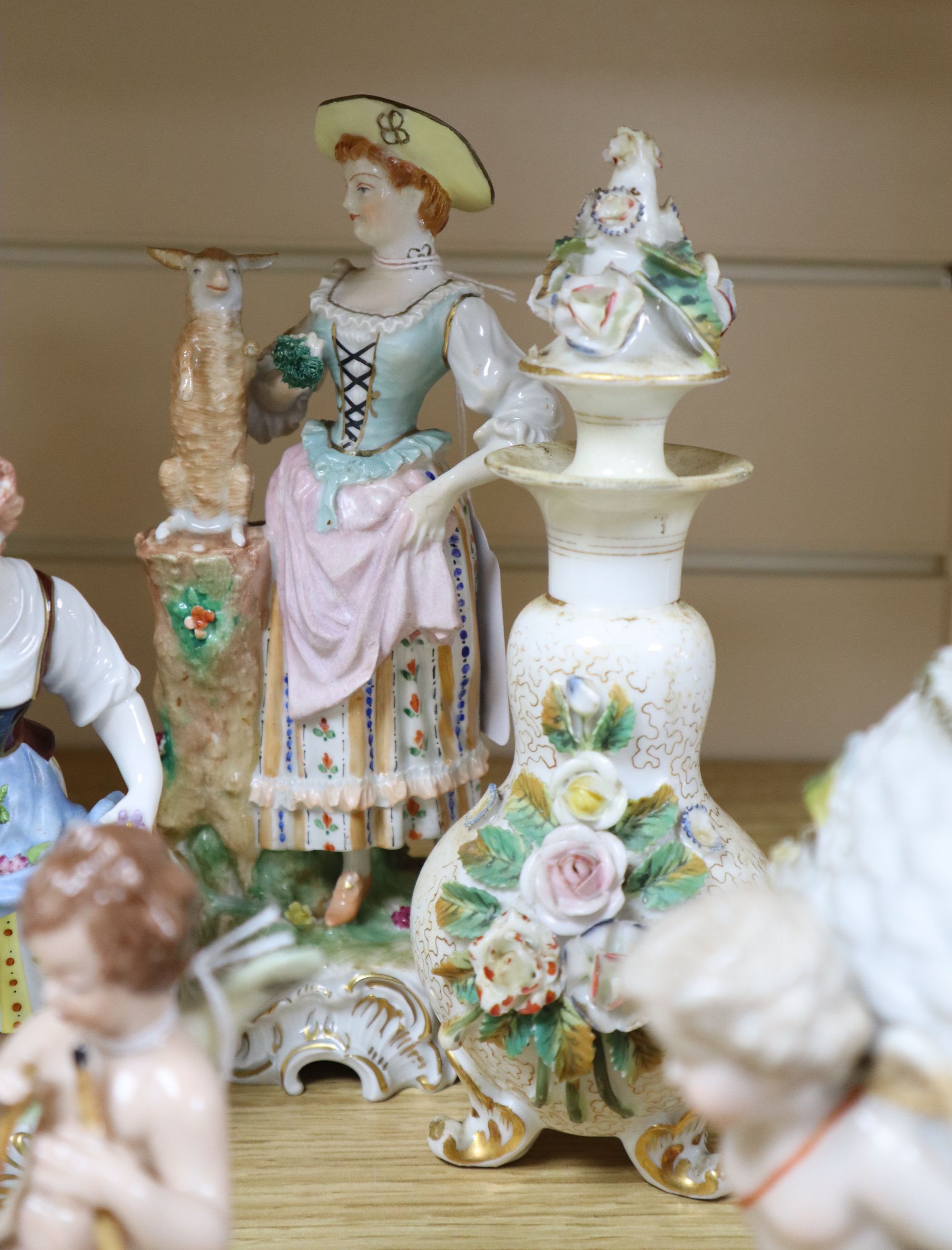 A Sitzendorf flower-encrusted egg-shaped porcelain vase with cherub supports and six other items,